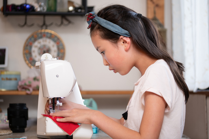 Photo of child sewing