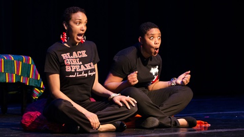 Photo of 2 girls on stage, excited.